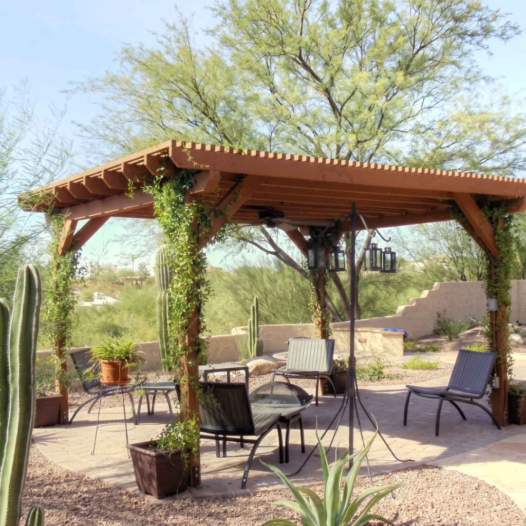 Wood pergola with chandelier, cacti, and desert garden patio